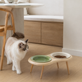 Elevated cat feeding station with two ceramic bowls on wooden legs in modern Australian kitchen