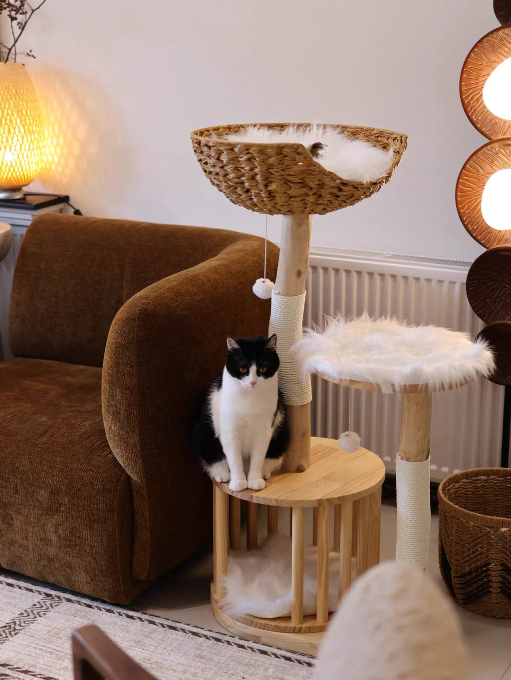 Cat relaxing on wooden cat tower with woven basket bed in warm living room